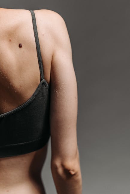 Close-up of a person's back muscles engaged during a controlled yoga movement