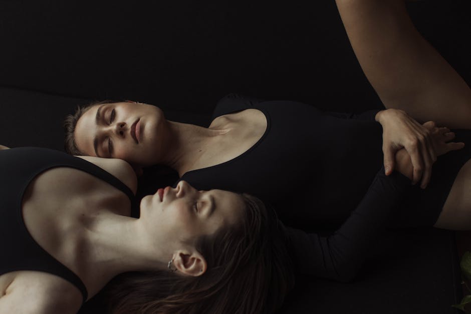 Woman practicing a gentle backbend yoga pose in a warmly lit, serene studio